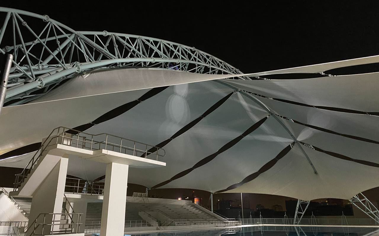 Arched space truss and membrane panels of the Dubai Men’s College pool shade